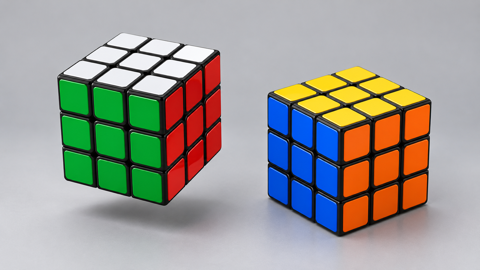 Two solved Rubik’s cubes on a light grey surface, one showing its white, green and red faces and the other its yellow, blue and orange faces